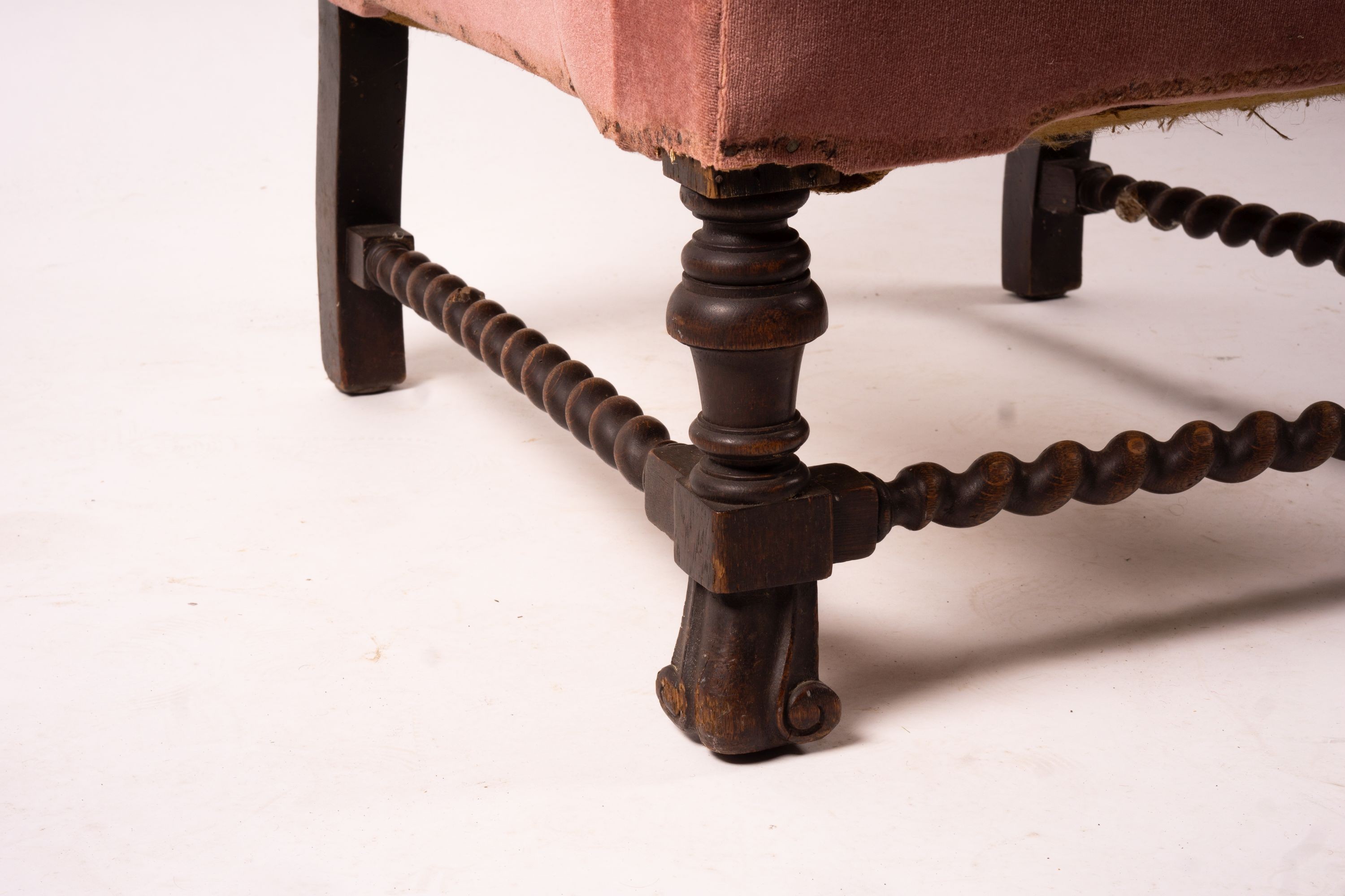 An early 20th century Jacobean revival upholstered wing armchair, width 84cm, depth 90cm, height 128cm